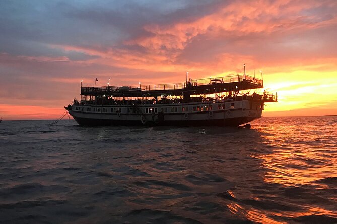 Sunset Dinner and drinks includes a Floating Village cruise tour. - Crocodile/fish farm peek: quick look, keep an open mind